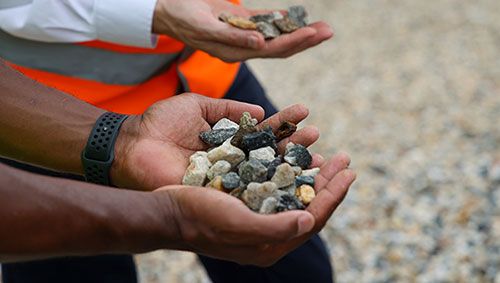 Man's hands holding repurposed aggregate