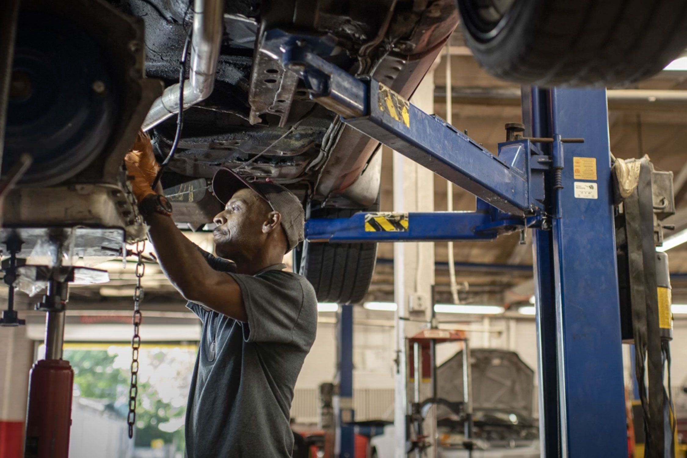 Man in an auto shop working a car