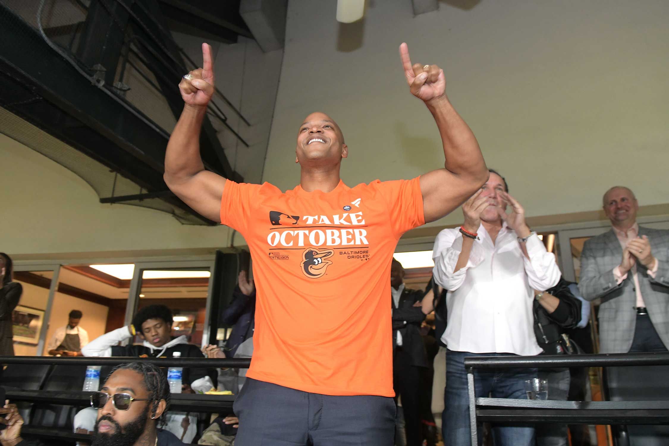Governor Wes Moore stands and cheers on the Baltimore Orioles