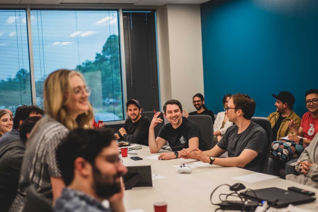 Bit Reactor employees sitting around a table and talking