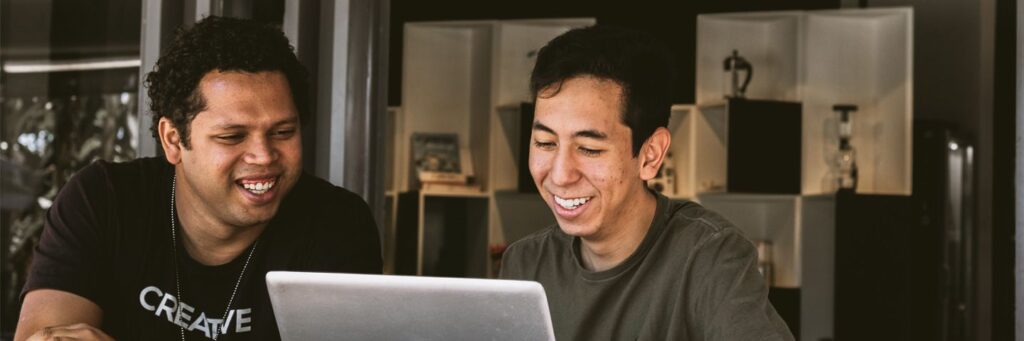 2 men looking at computer