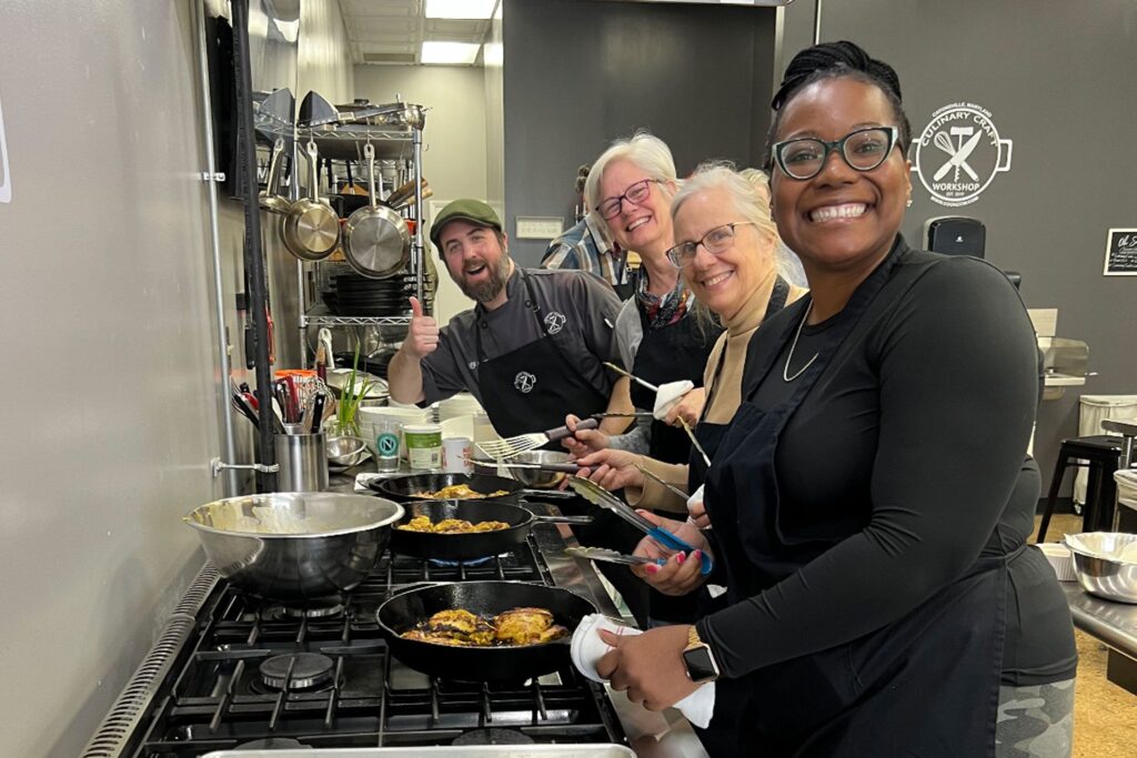 A group of people making pasta