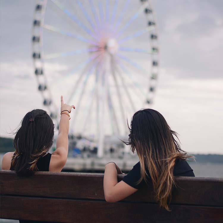 Women watching ferris wheel