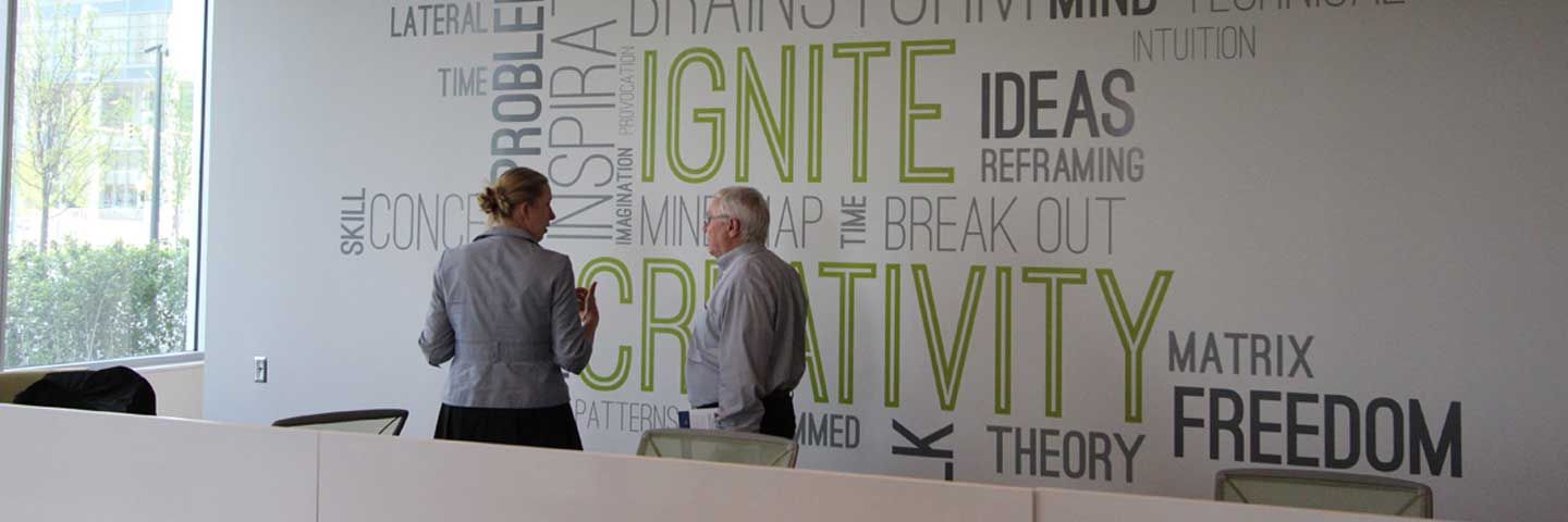 A wall with positive business sayings written on it