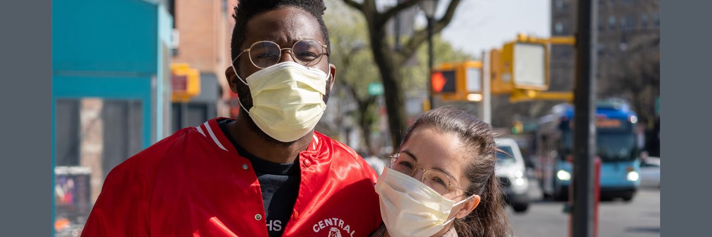 Image of two people wearing masks