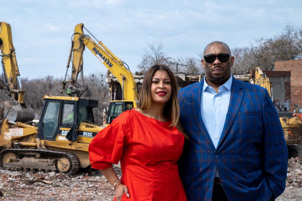Pless and Elizabeth Jones stand in front of construction equipment