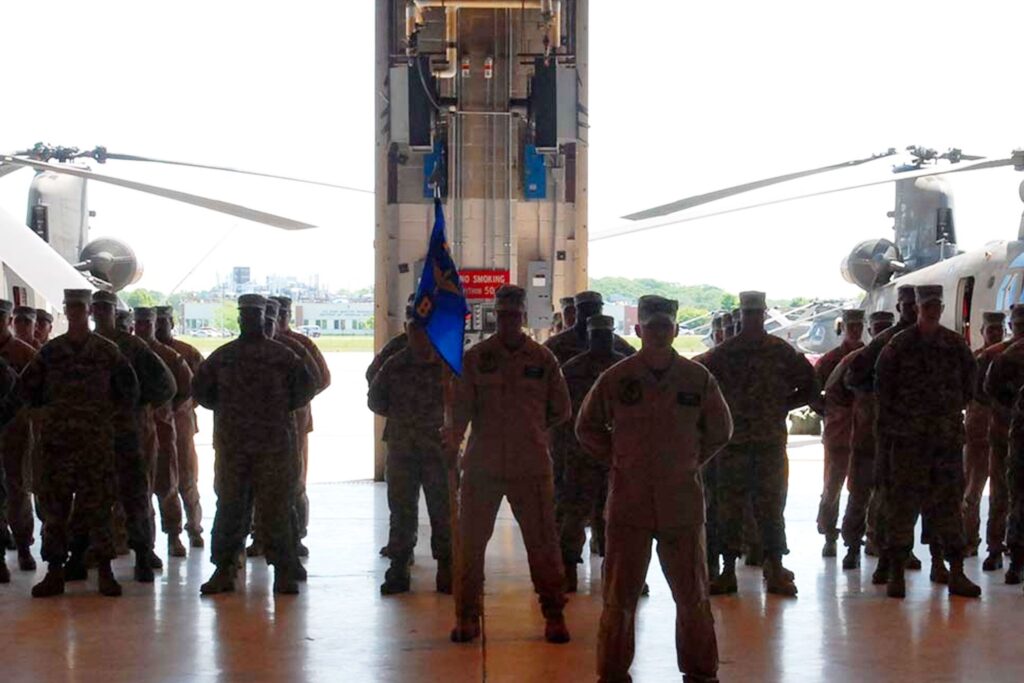 Military members standing near aircraft