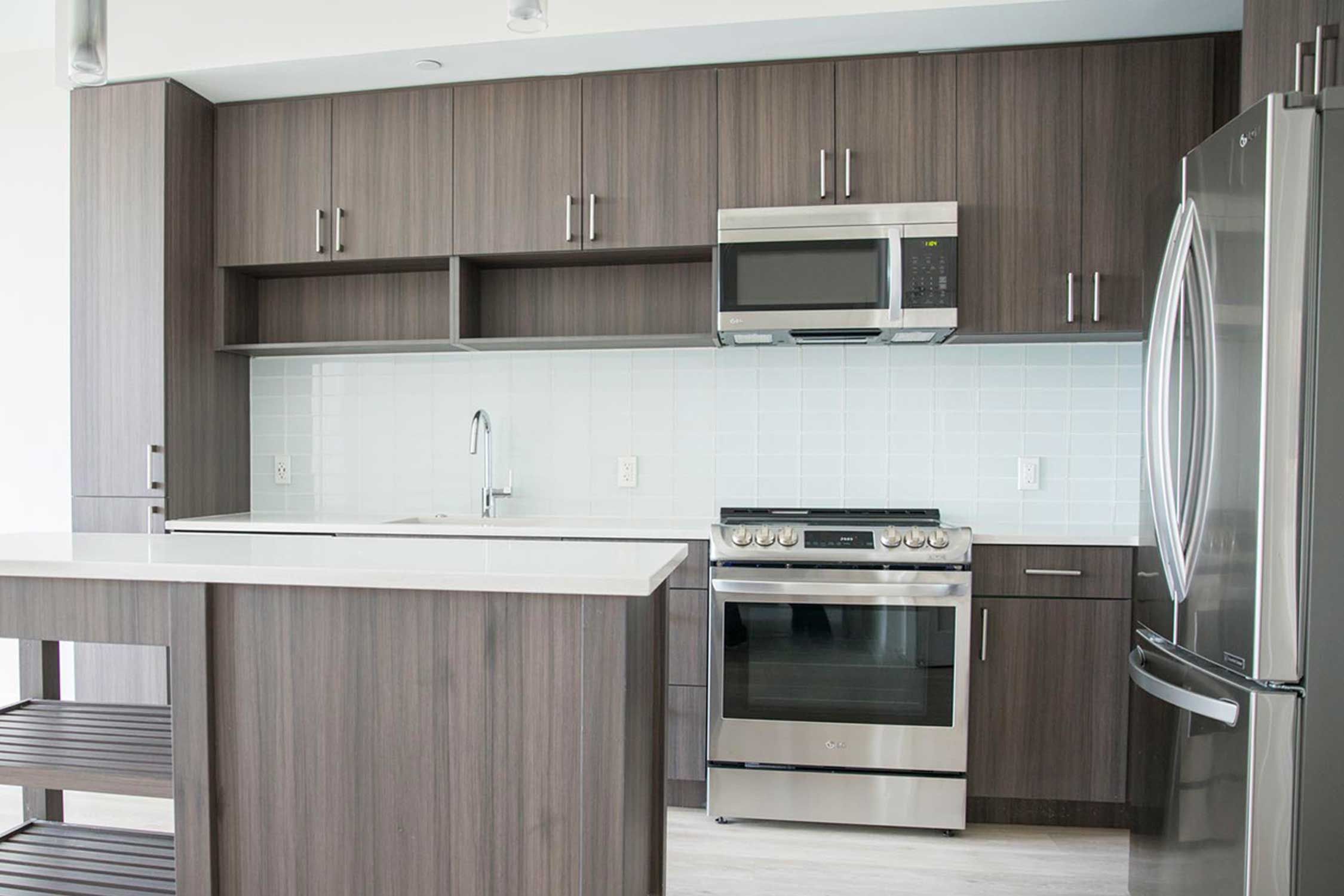 A kitchen with brown wooden cabinets and stainless steel appliances