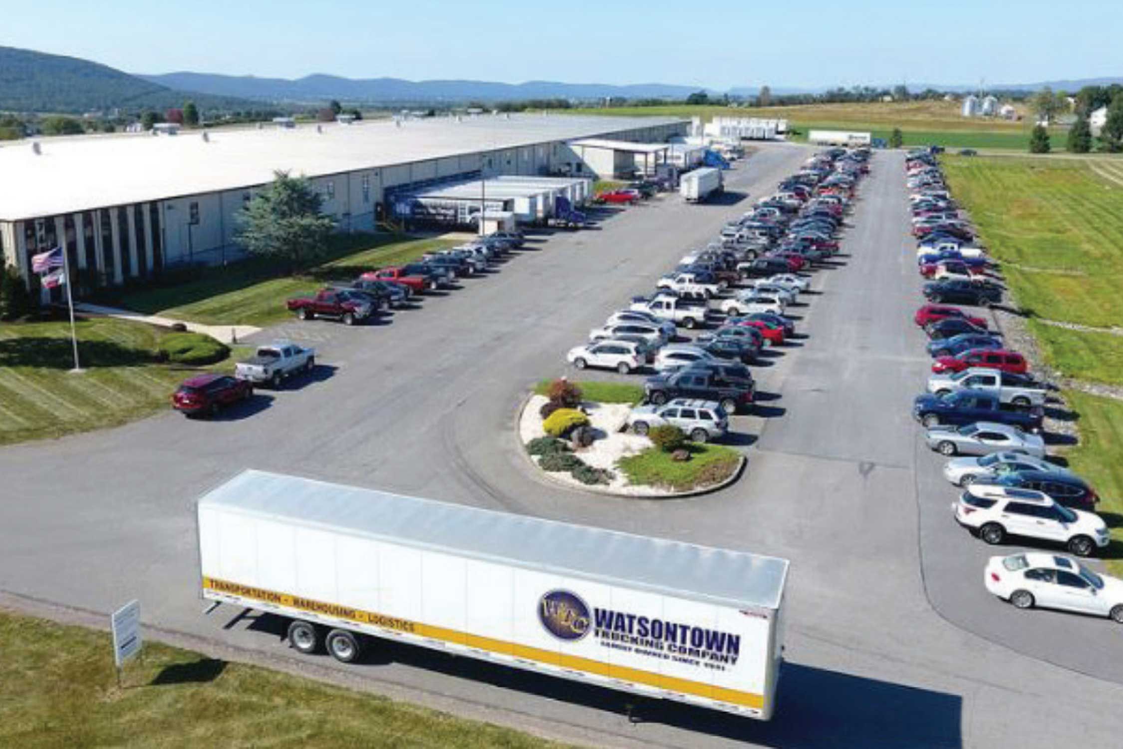 An office parking lot with company trucks and vehicles