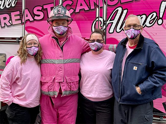 Four individuals from the For 3 Sisters nonprofit dressed in pink