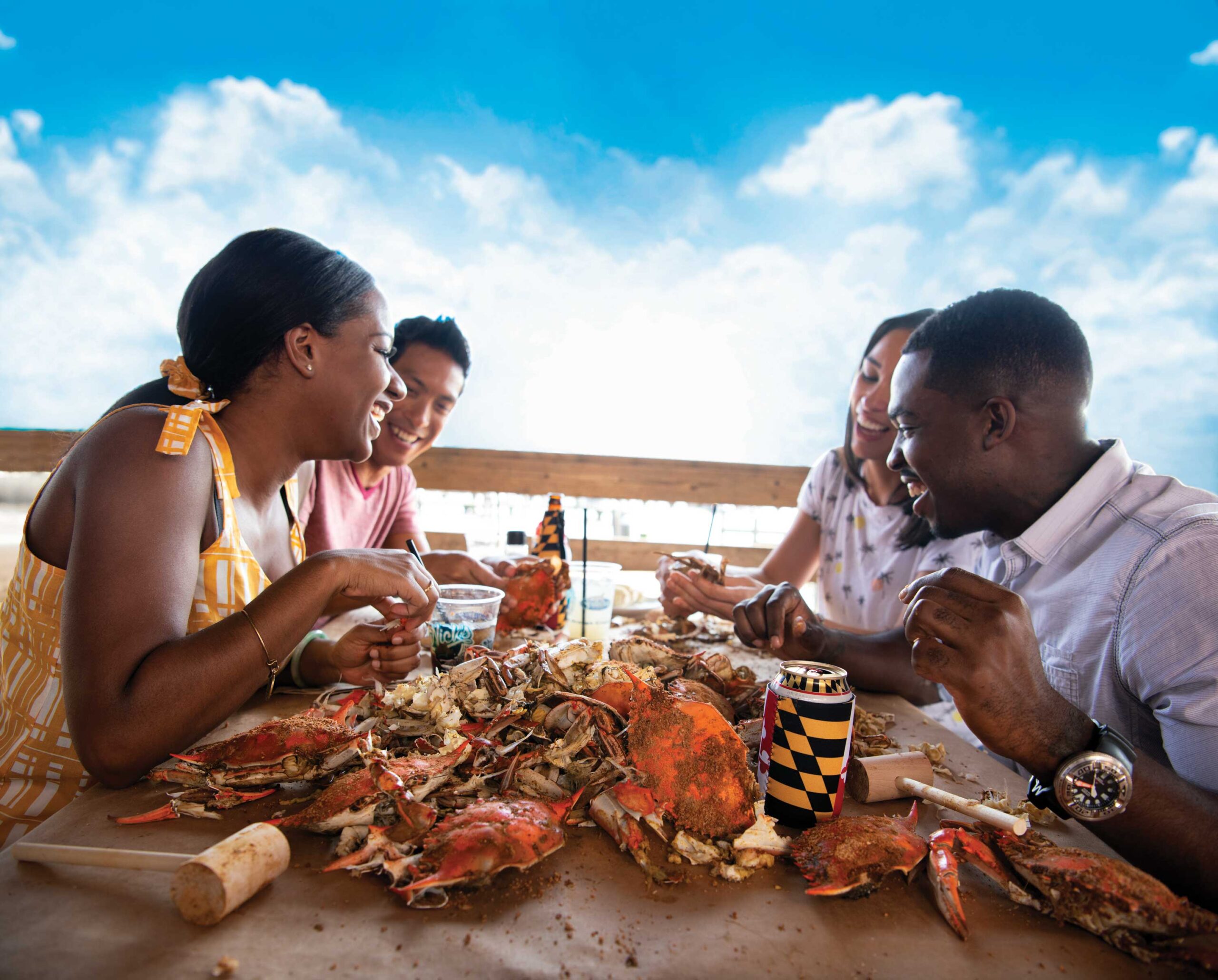Four people enjoying a crab feast in Maryland