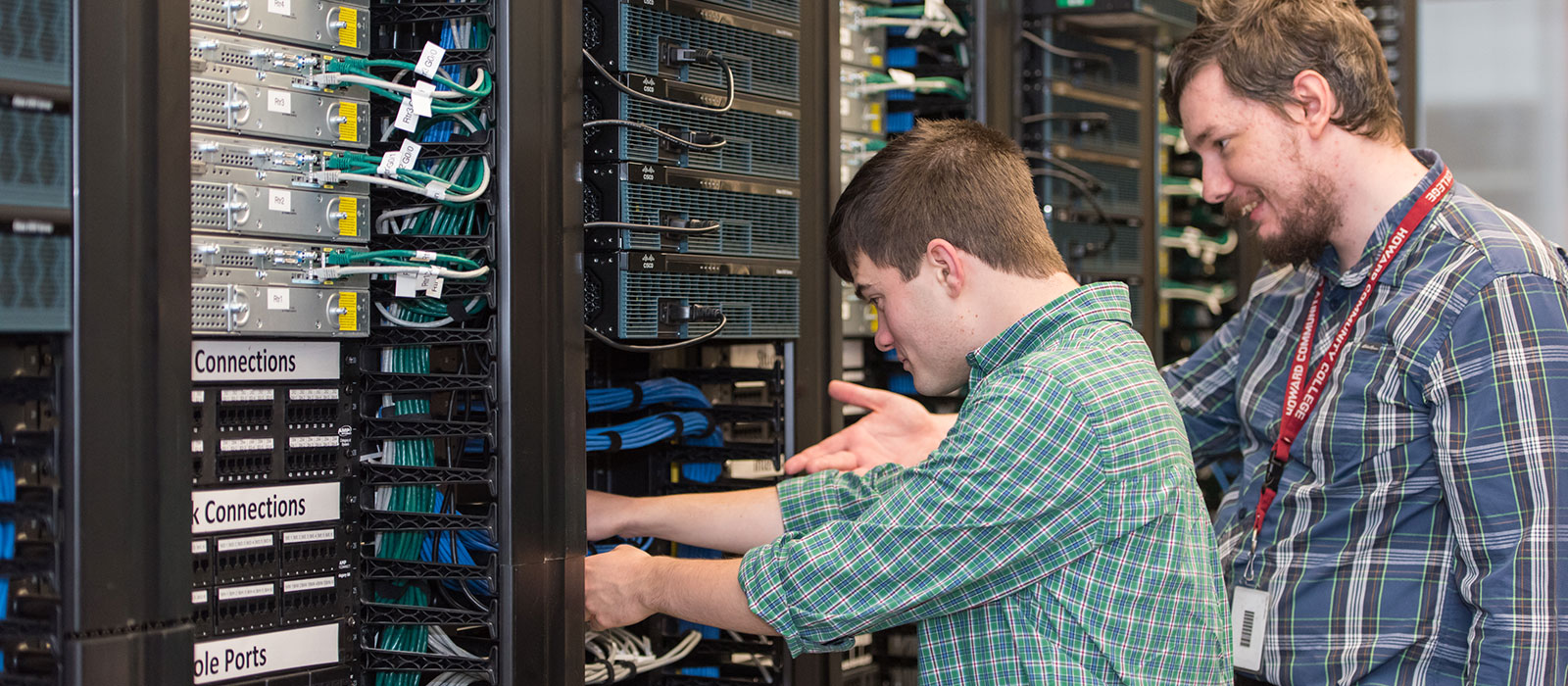 Two students working in a server room at Howard Community College