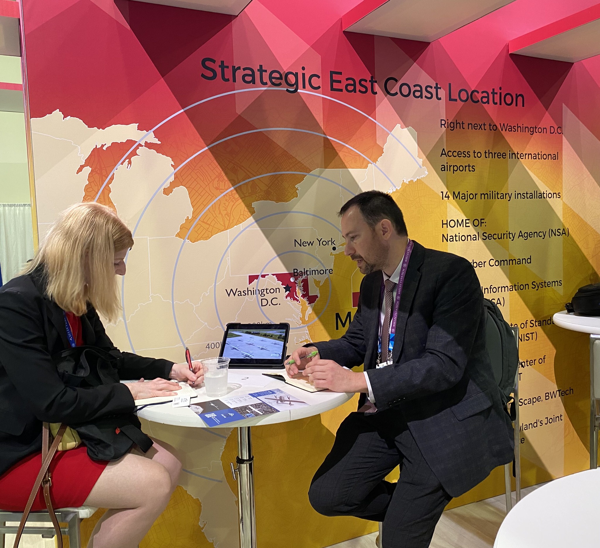 People meeting at a Maryland trade show booth