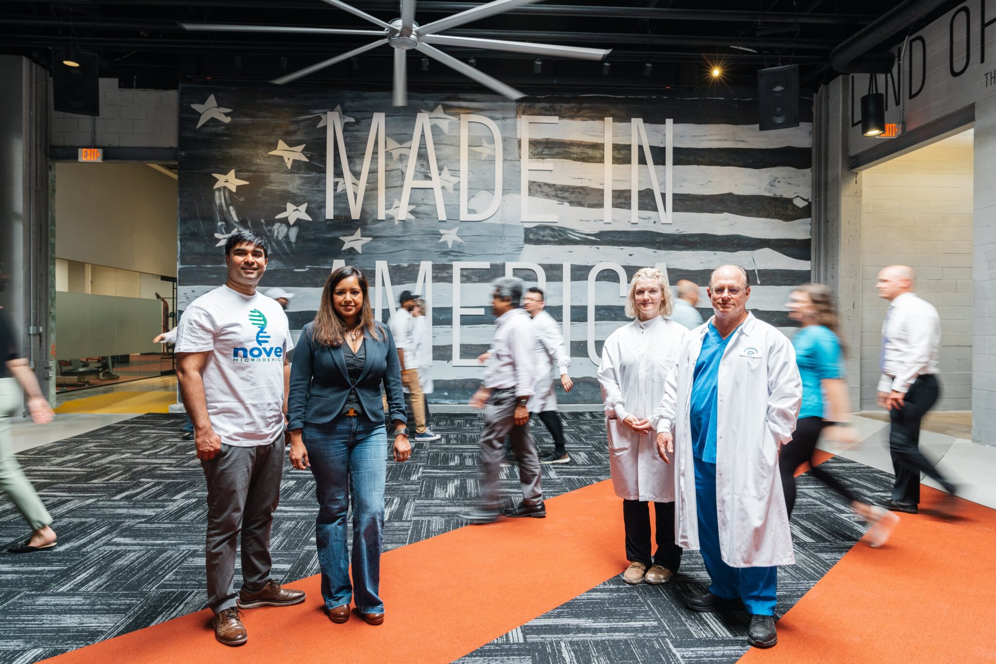 A group of people standing in the lobby at City Garage, in front of a "Made in America" sign