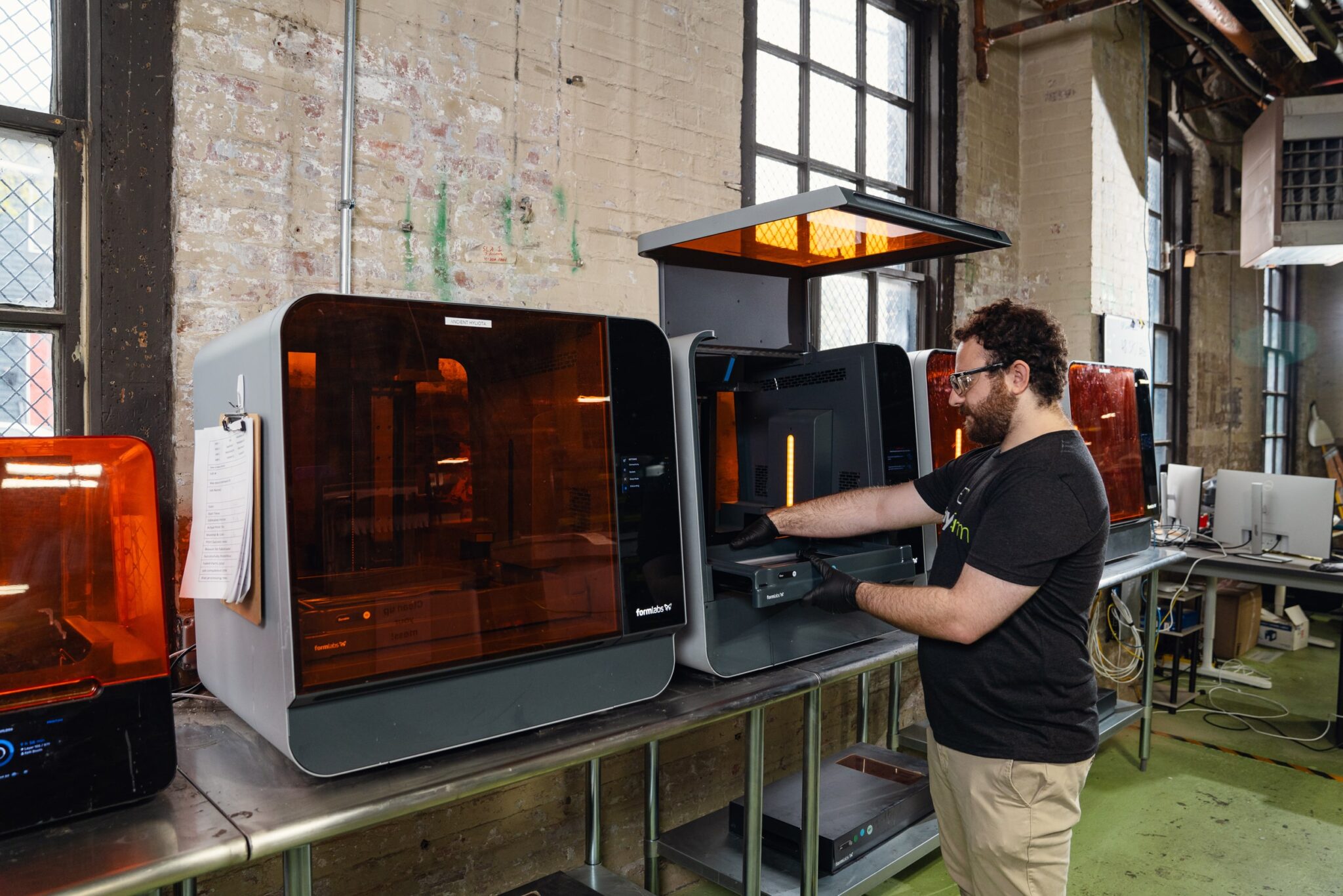 A person using a 3D printer at Early Charm Ventures in Baltimore