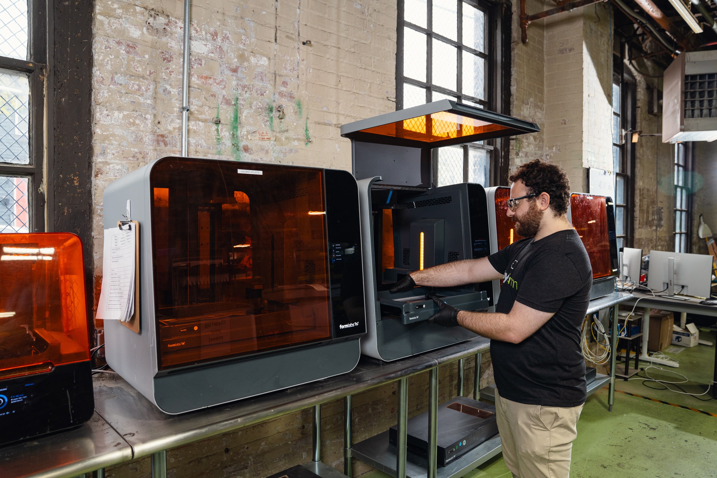 A person using a 3D printer at Early Charm Ventures in Baltimore