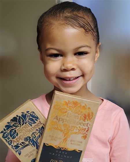 a young girl poses with chocolate bars