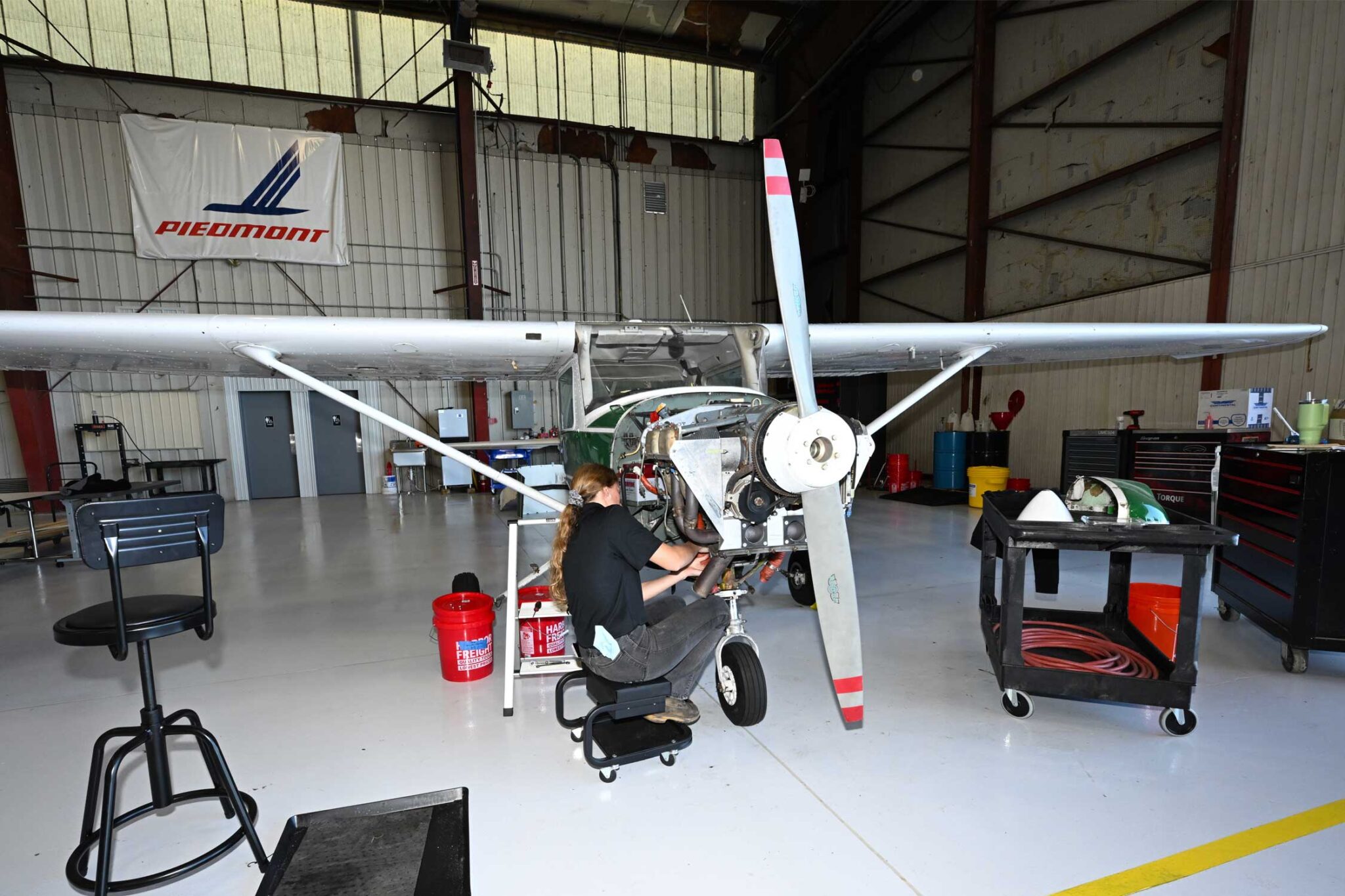 a mechanic works on a small plane propeller