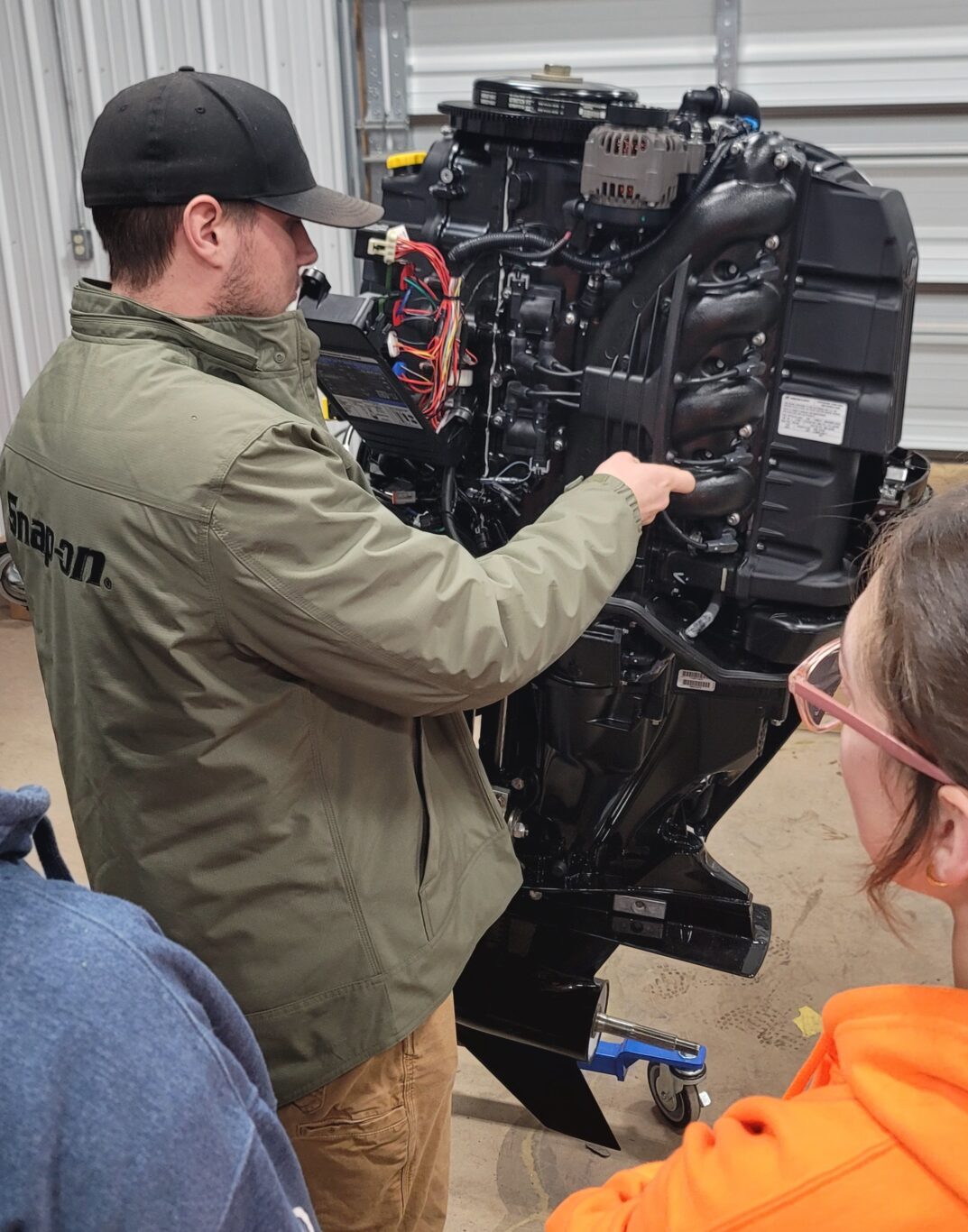 image of student working on boat motor 