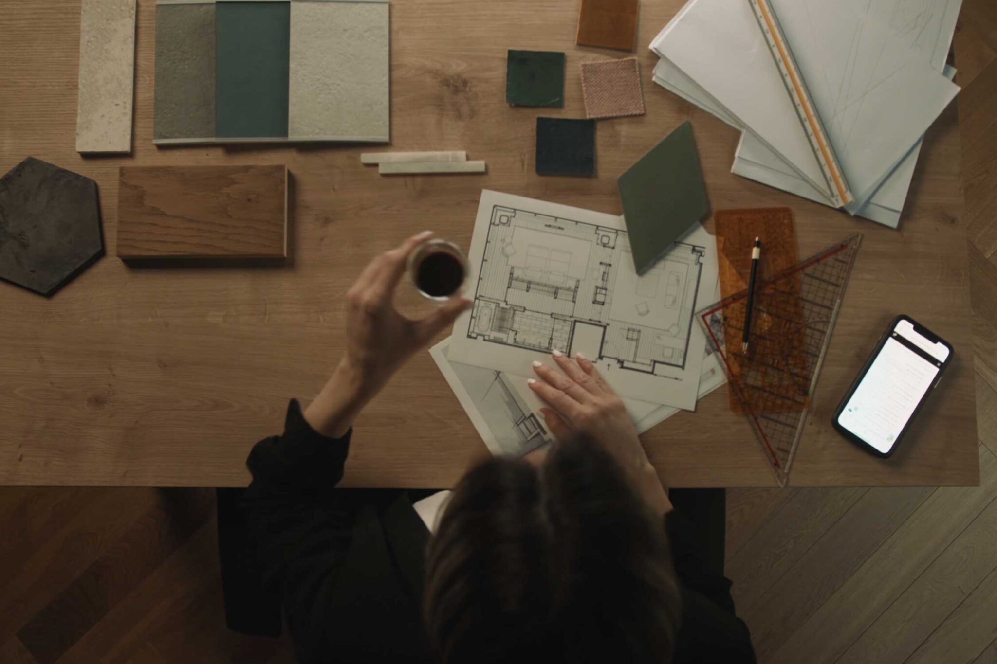aerial view of building materials and blueprints on a desk