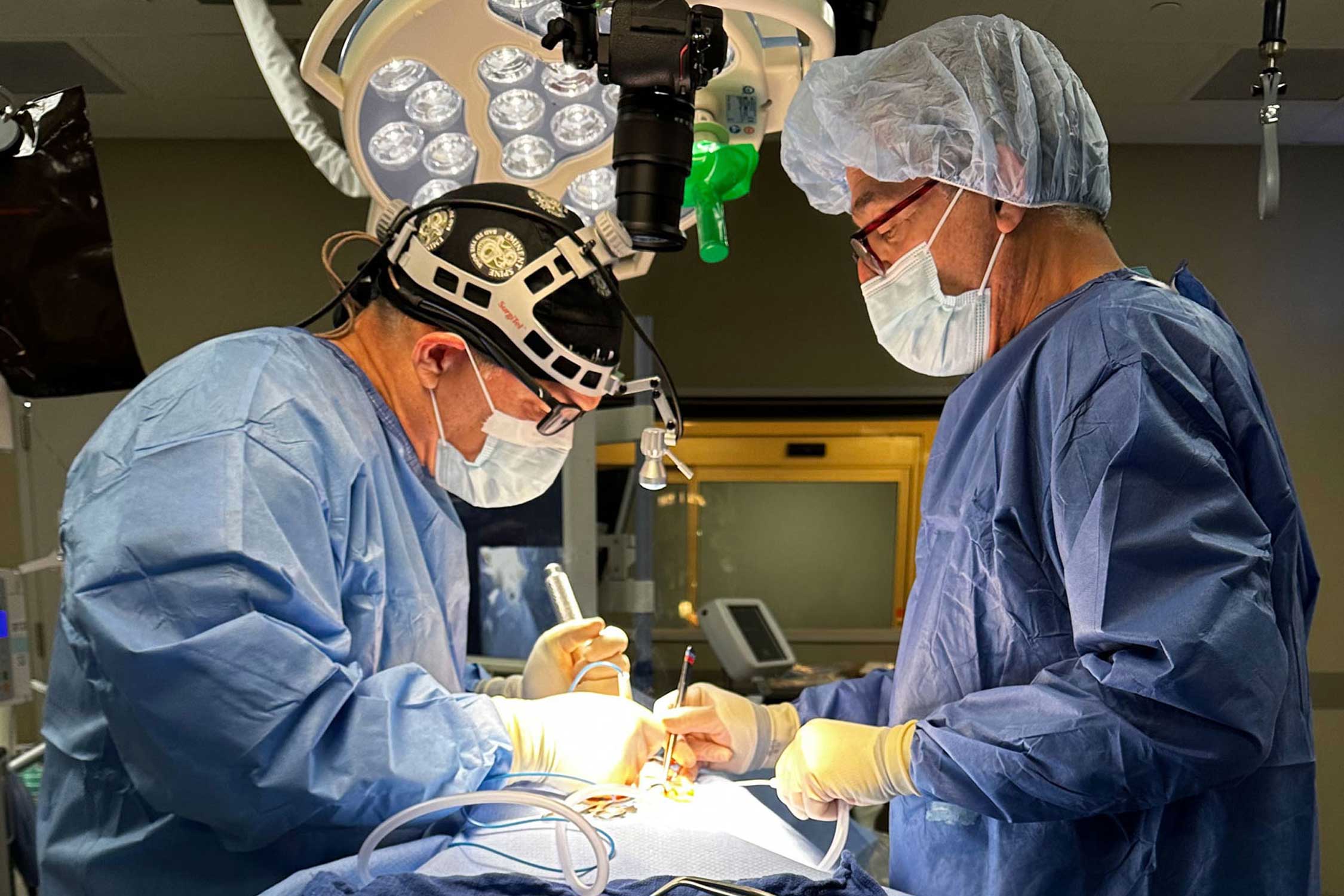 two medical professionals perform a procedure, photo courtesy of Medcura