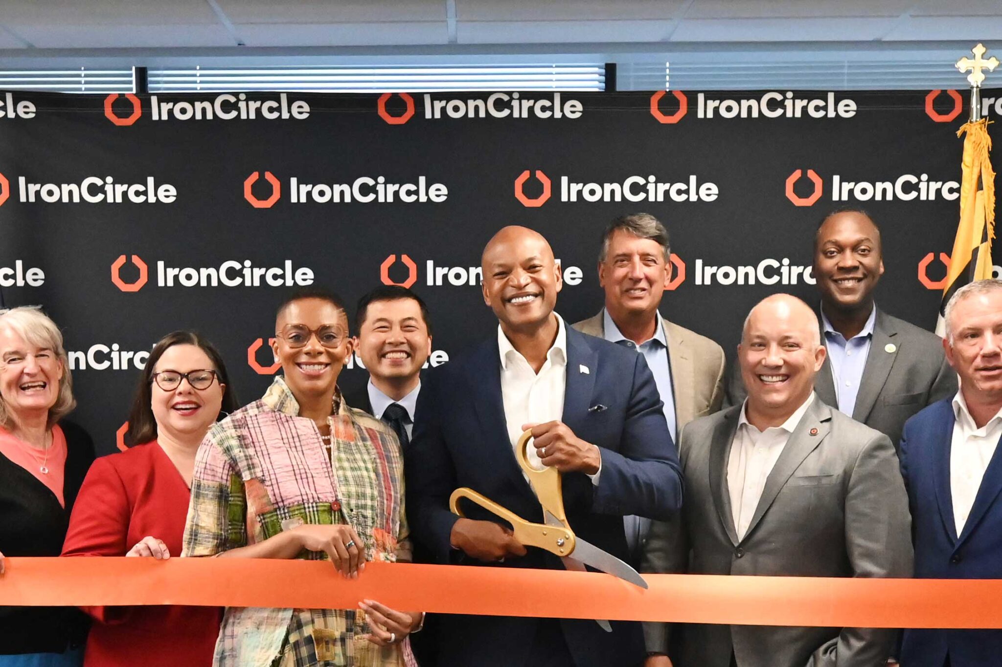 IronCircle cuts a large red ribbon at its Howard County grand opening ceremony