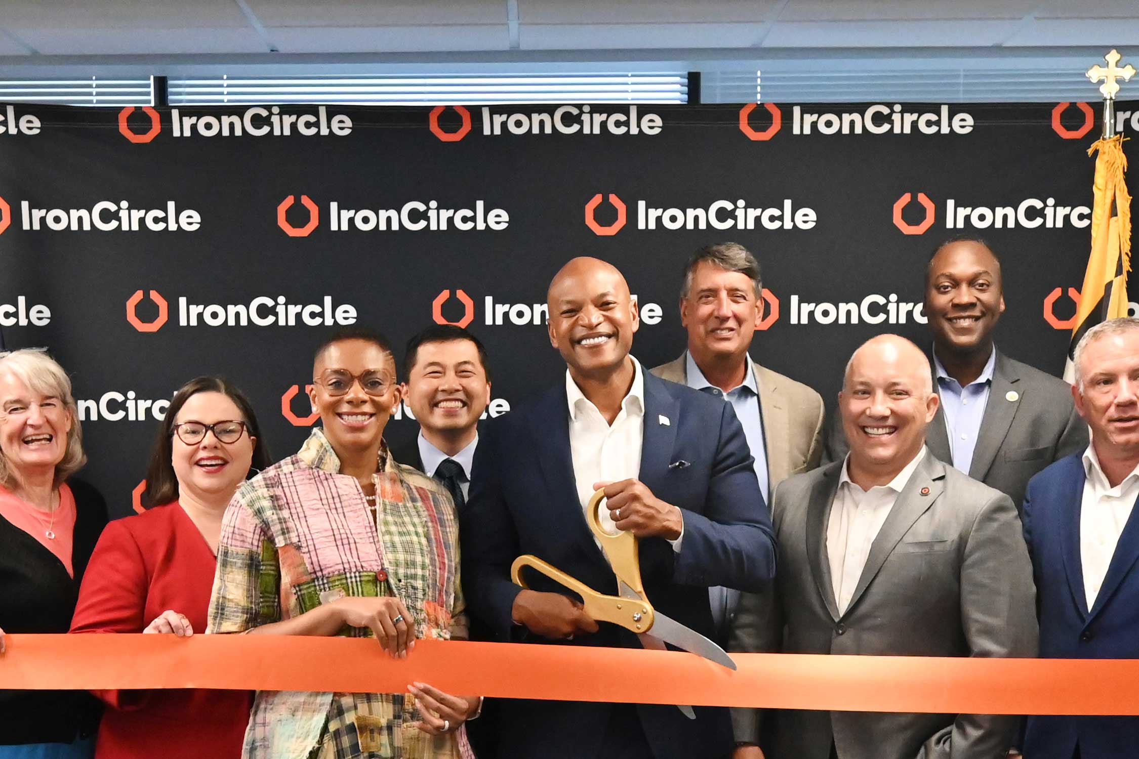 IronCircle cuts a large red ribbon at its Howard County grand opening ceremony