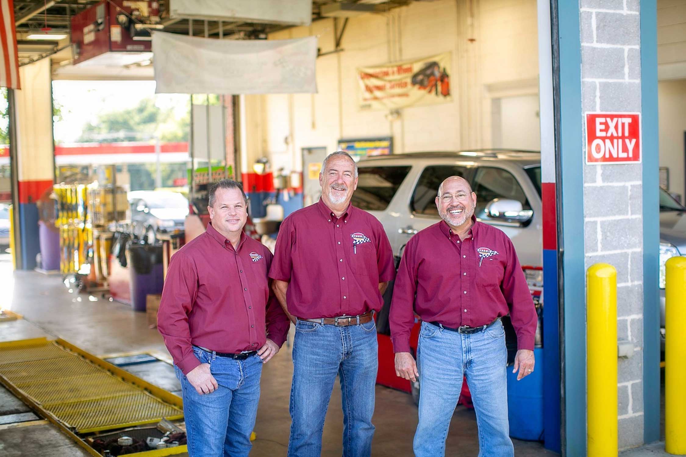 Dynamic Automotive employees pose for a photo in an automotive repair facility