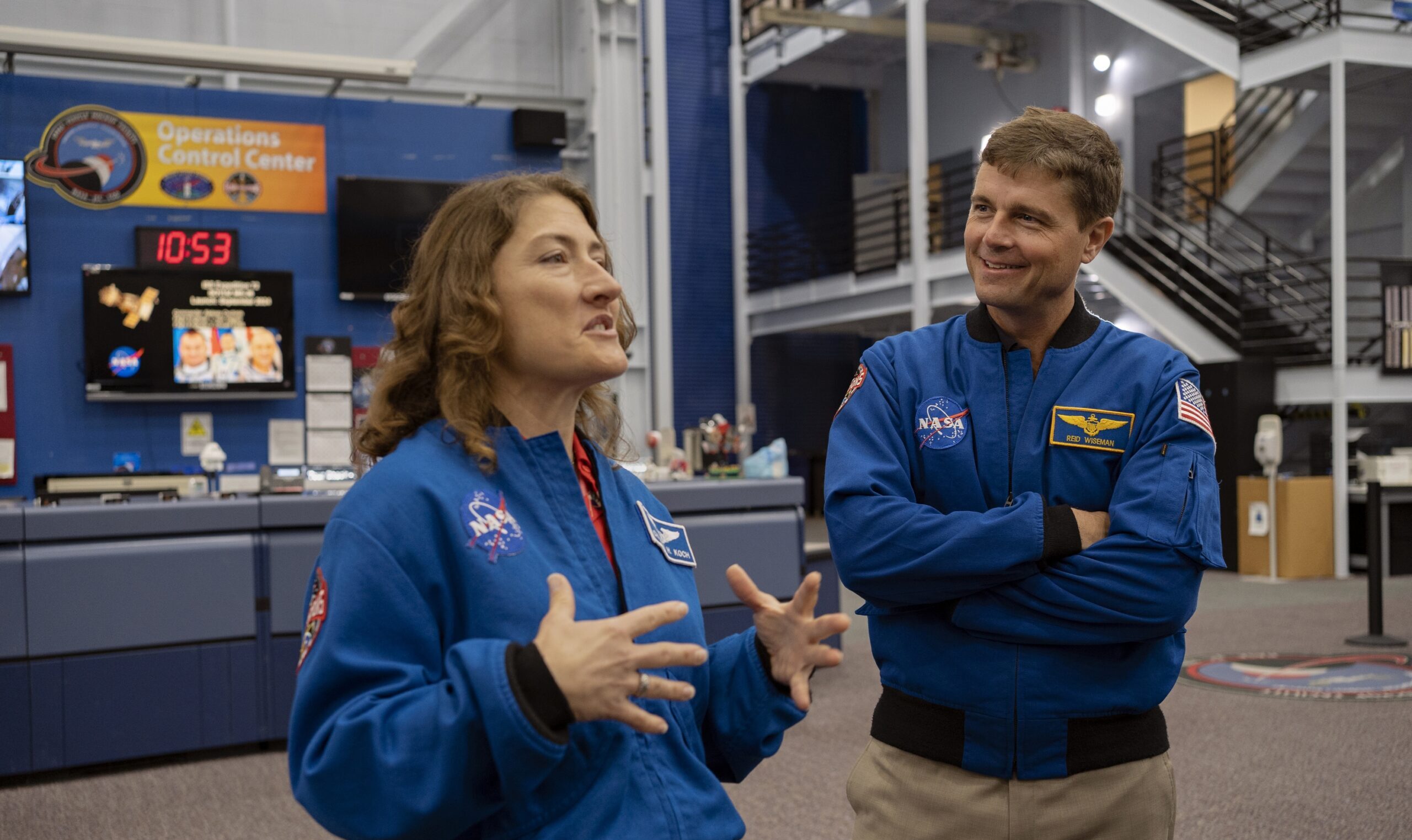 Astronauts Christina Koch and Commander Reid Wiseman in their NASA jackets