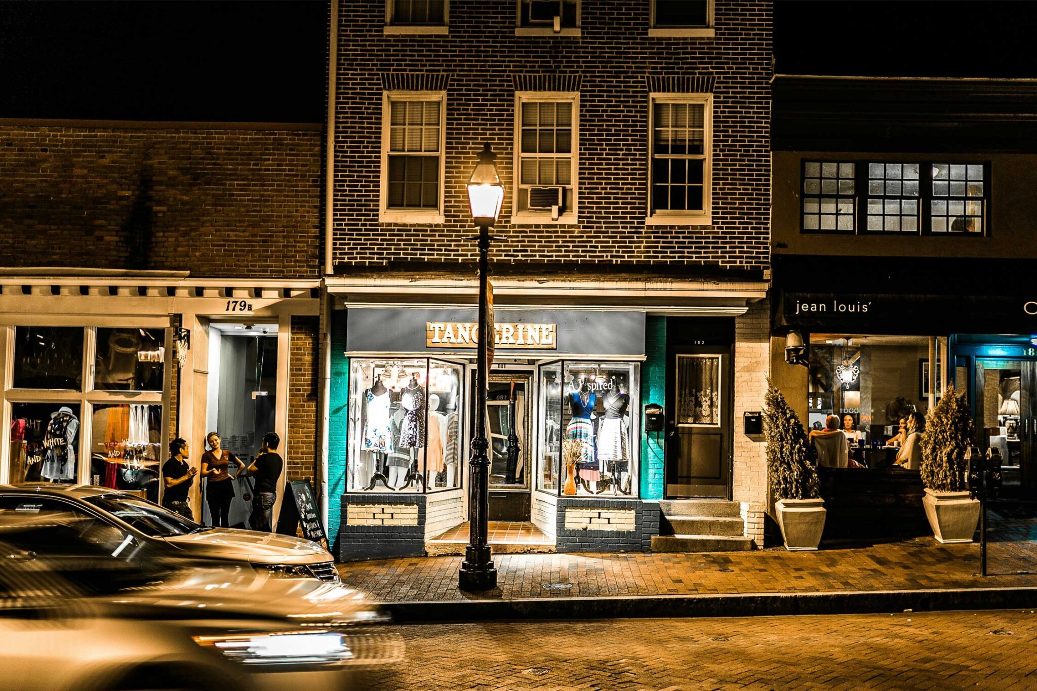 a night view of retail shops on a street in Annapolis