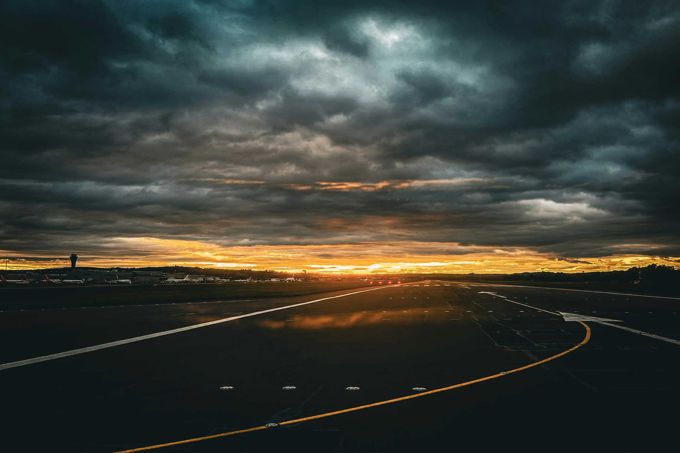 dark storm clouds hover over an airport