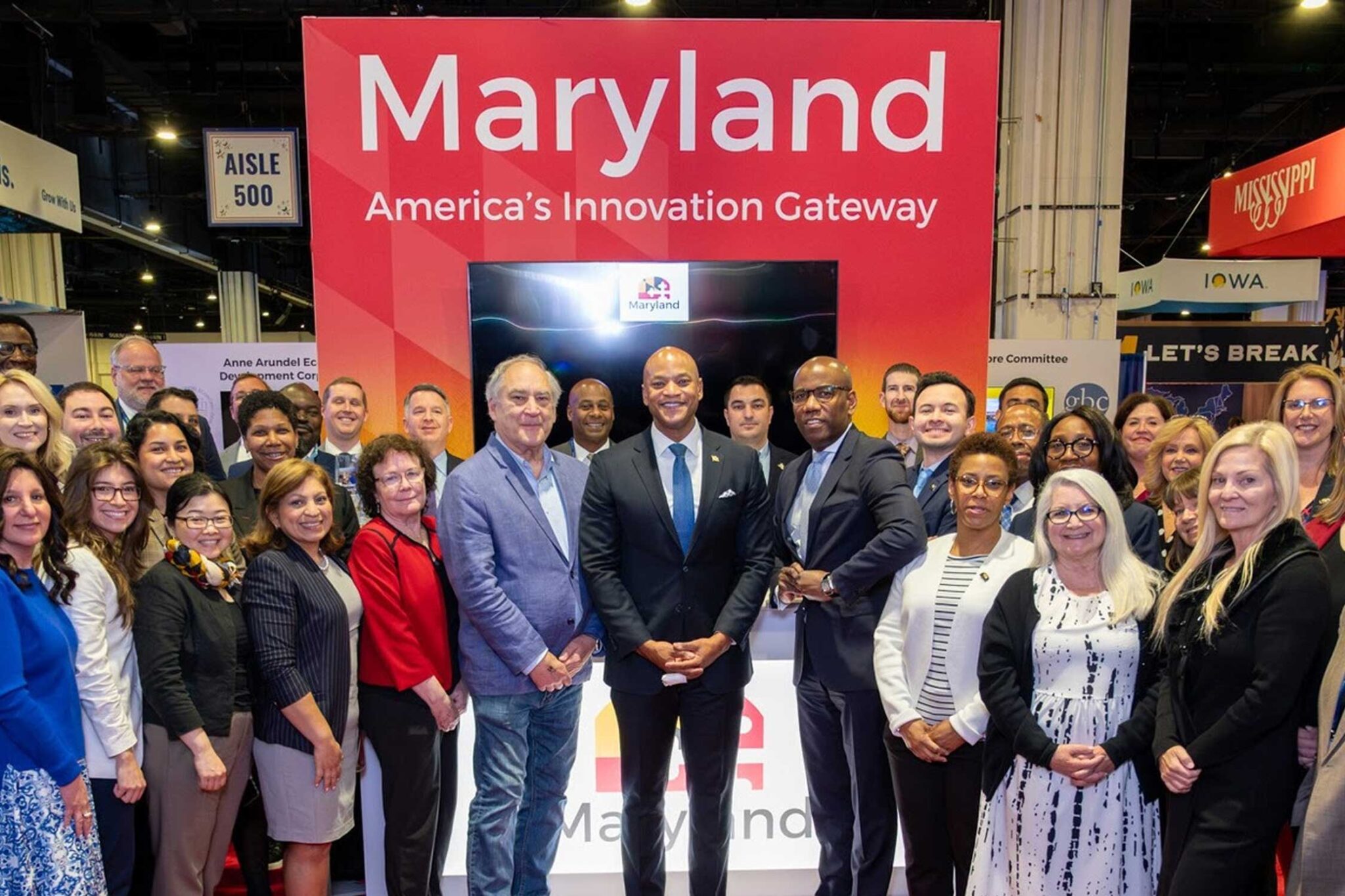 Maryland officials stand in front of Maryland booth at the SelectUSA Summit (2026)